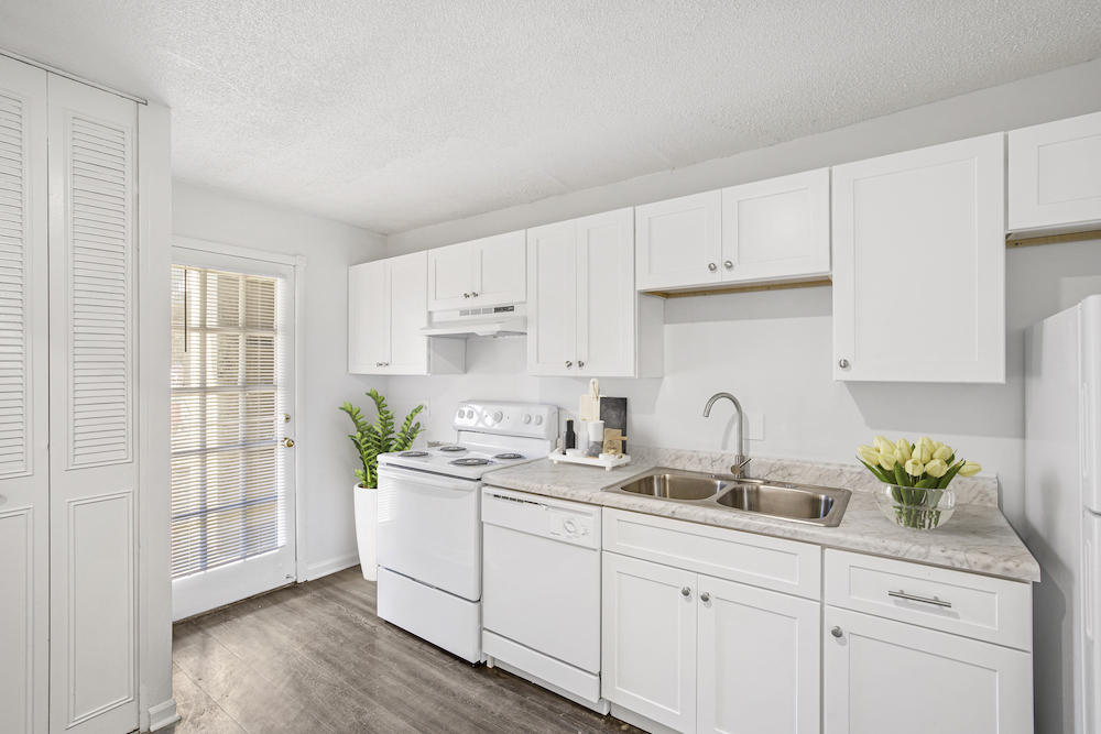 kitchen with white appliances and white cabinets